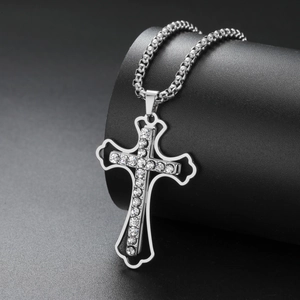 Macro shot of silver stainless steel cross pendant with sparkling rhinestones detail