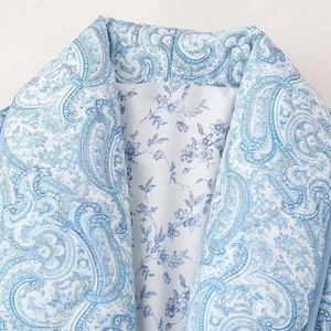 Floral cotton jacket featuring a stylish lapel with blue and white paisley patterns