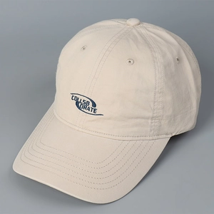 Detail of embroidered COLLSB ORATE text on a washed cotton baseball cap brim