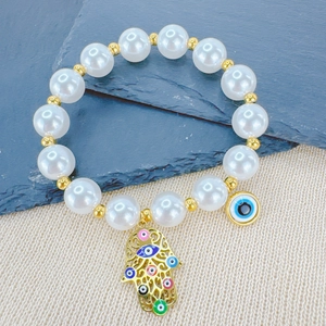 Bohemian pearl beaded bracelet with gold Fatima hand and colorful evil eye charms