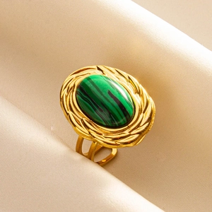 Detail of vintage adjustable gold ring featuring an oval green malachite gemstone