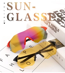 Detail view of two sporty cycling sunglasses with red and black frames and colorful lenses