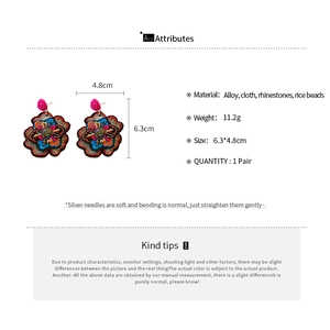 Detail view of colorful embroidered flower earrings with precise size and weight specs