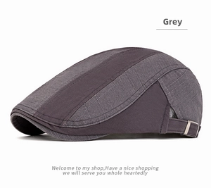 Detail of adjustable metal buckle and grey patchwork texture on a cotton flat cap