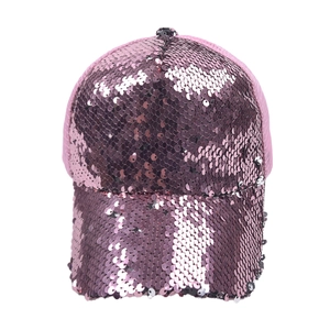 Detailed view of pink and purple reversible sequins and mesh fabric on a baseball cap