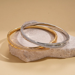 18k gold plated bangle with sparkling cubic zirconia on a natural stone base