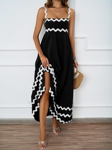 Detail of summer black maxi dress with white wavy trim and elegant spaghetti straps