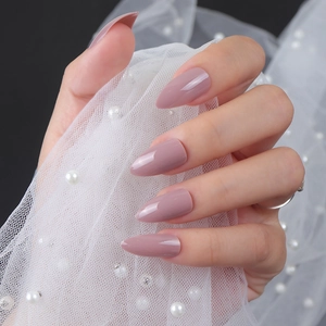 Glossy mauve almond press-on nails shown against elegant pearl tulle background