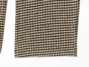 Detailed close-up of houndstooth woven fabric showing fine stitching and texture