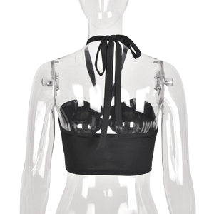 Detail of black halter crop top featuring crisscross back lace-up ties and cutout design