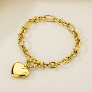Close-up of gold heart pendant bracelet with a stylish OT toggle clasp and chunky chain
