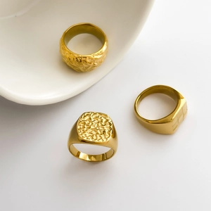 Set of vintage gold embossed rings featuring crater and lava textures in stainless steel