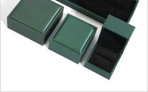 Deep green luxury jewelry box set featuring ring, pendant, and bracelet cases with black lining