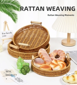 Set of three hand-woven rattan trays with wooden handles for bread and fruit storage