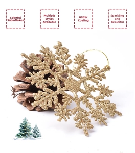 Detail of a sparkling gold Christmas snowflake ornament with fine glitter and hanging loop