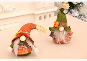 Detail view of harvest gnomes with autumn maple leaves, sunflowers and classic plaid patterns