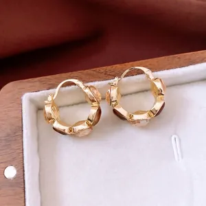 Vintage gold square hoop earrings with brown champagne crystals on velvet background