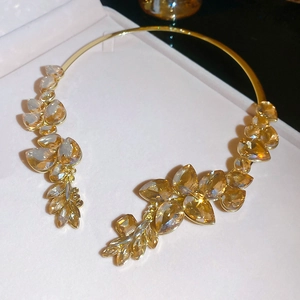 Detail of champagne crystal droplet open choker necklace in gold-tone setting
