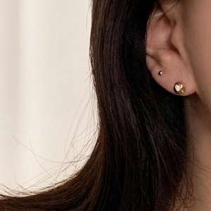 Minimalist 925 sterling silver gold stud earrings with round cubic zirconia on model