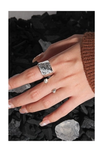 Macro shot of silver S925 ring featuring irregular hammered texture on model hand