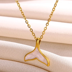 Detail shot of the golden fish tail pendant with white mother of pearl inlay on chain