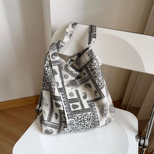 Detail of vintage paisley print canvas tote bag with Simple Wish label on white chair