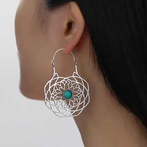 Bohemian silver mandala earrings with green stone center shown on model for women
