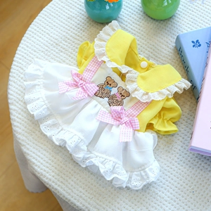 Detail of pet princess dress featuring daisy yellow fabric and lace layers for small dogs