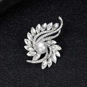Elegant rotating flower brooch with white pearl and marquise cut crystals in silver finish