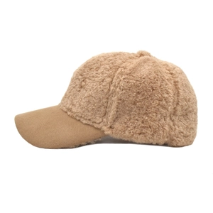 Close-up of brown plush baseball cap texture featuring thick fleece and curved brim