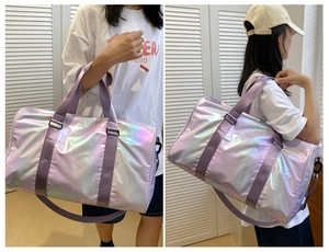 Detail view of iridescent holographic duffel bag with purple straps for gym and travel