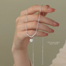 Detail of S925 sterling silver flower necklace featuring a delicate pendant and thin chain