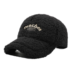 Winter black sherpa baseball cap with gold peach embroidery in a side profile view
