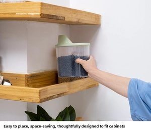 Kitchen storage jar for grains with easy-grip side and green pouring lid in a cabinet