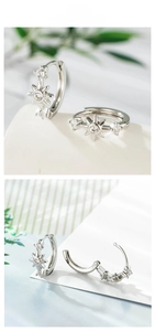 Detail of silver starburst hoop earrings with zircon stones and snap-on clasp structure