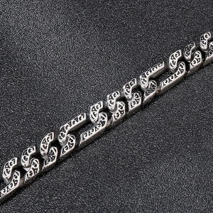 Detail of vintage silver titanium steel chain bracelet with engraved floral patterns