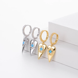 Detail view of heart-shaped evil eye earrings with blue opal and white zircon stones