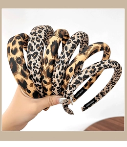 Macro shot showing diverse leopard print patterns and hand-made label on fabric headbands