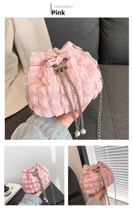Pink drawstring bucket bag with quilted texture, silver chain strap and pearl detail