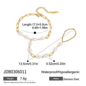 Detailed view of stainless steel slave bracelet with white pearls and gold chain links