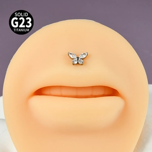 Macro shot of silver G23 titanium butterfly labret with marquise crystals on lip model