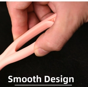 Detailed close-up showing the smooth rounded design of pink manual lint remover tool