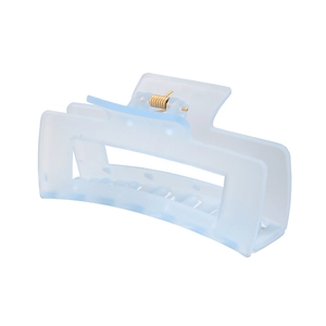 Detail of light blue matte hair claw clip with golden metal spring and hollow design