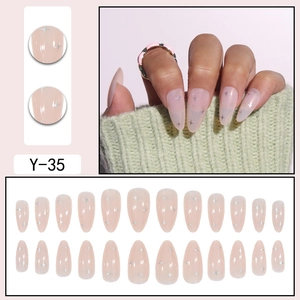 Short almond press-on nails in nude pink with silver star sequins and 24-piece set layout