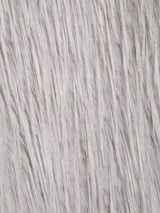 Macro shot of silver-grey faux fur texture showing smooth fibers and natural gloss