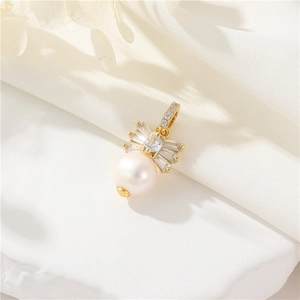 Elegant 14K gold-filled pearl pendant with sparkling zircon accents on white chiffon fabric