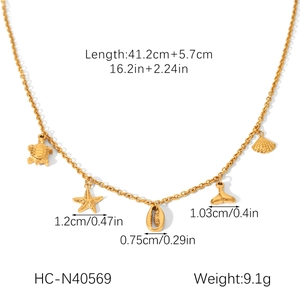 Detail view of gold ocean charms necklace with turtle and starfish measurement specs