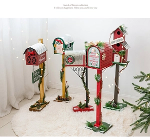 Cozy indoor Christmas setting with wooden mailbox and birdhouse floor ornaments