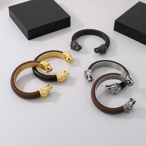 Detail of punk wolf head leather bracelets in gold, silver, and black metal finishes
