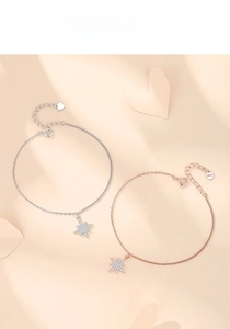 Close-up of S925 sterling silver stamp on heart charm of sparkling star bracelets